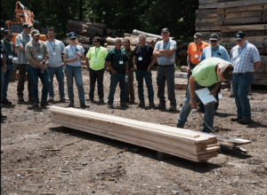 Timpro members gathered around to observe Mike Hinman grading newly sewn planks. 